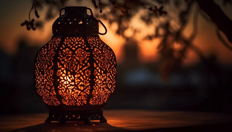 a lit lantern with a candle is a moroccan lanter